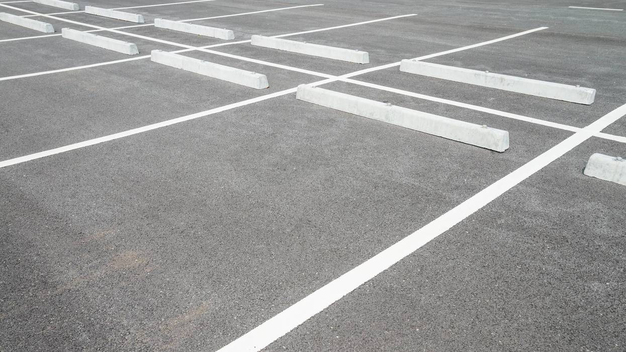 Empty space outdoor asphalt car parking lot (white line and concrete wheel stopper).