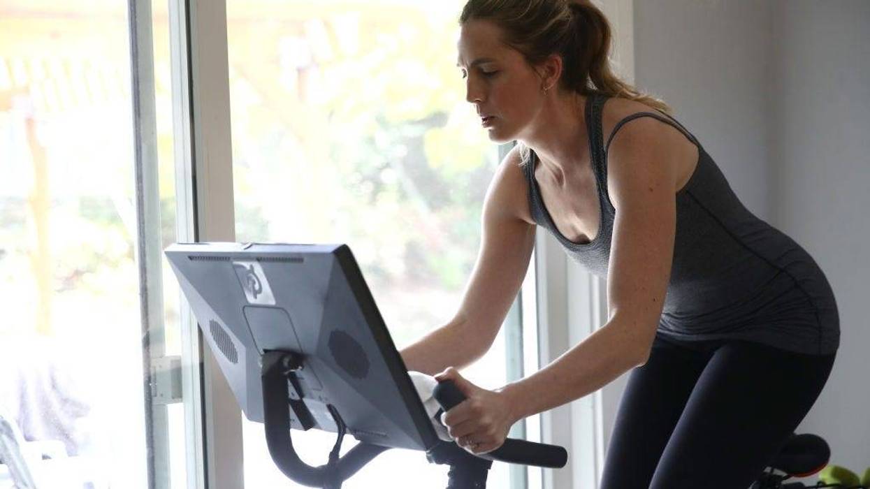 en Van Santvoord rides her Peloton exercise bike at her home on April 07, 2020 in San Anselmo, California.