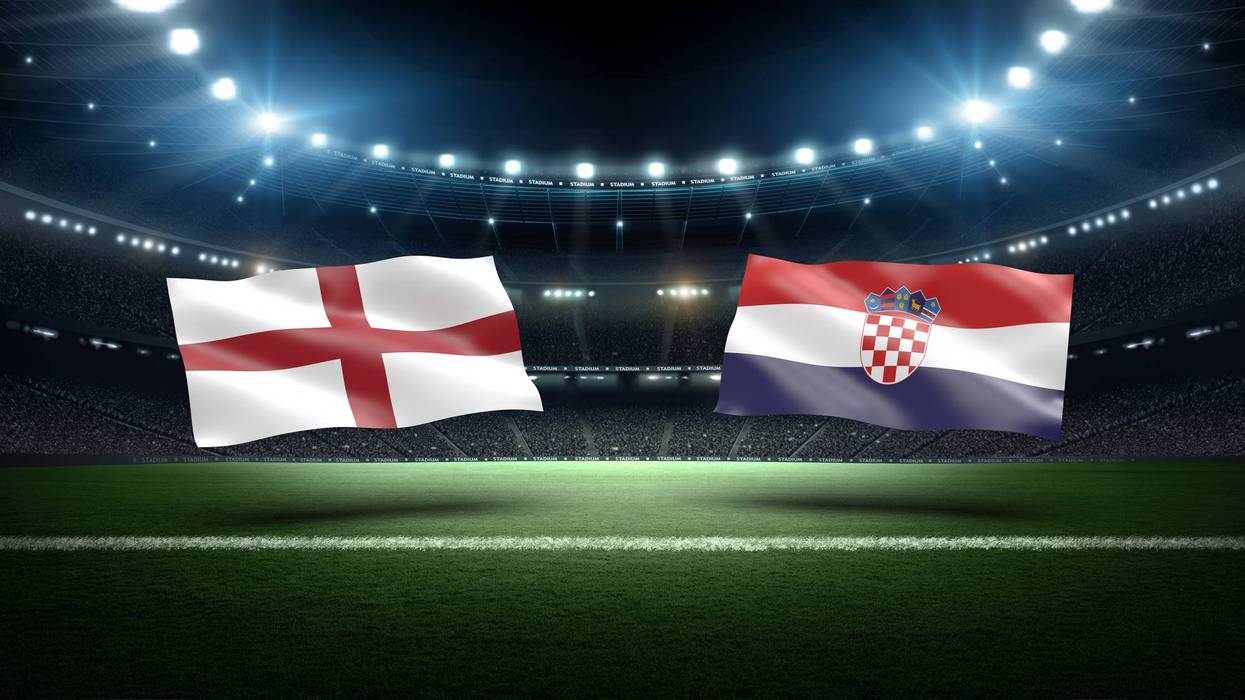 England and Croatia flags on soccer stadium field.