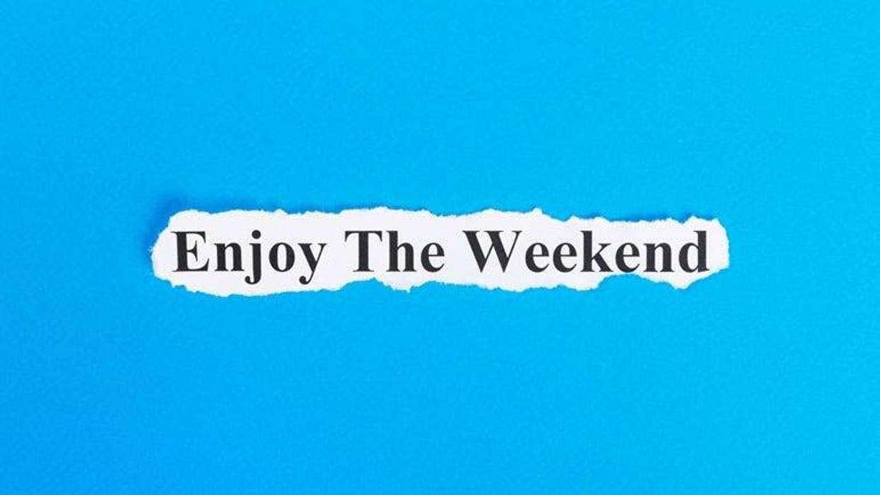 enjoy the weekend text on paper. Word enjoy the weekend on torn paper. Concept Image.