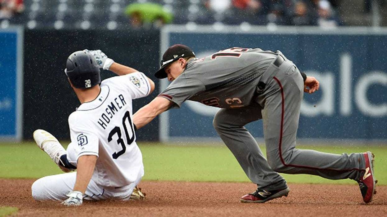 Eric Hosmer #30 of the San Diego Padres is tagged out at second base by Nick Ahmed #13 of the Arizona Diamondbacks during the fourth inning of a baseball game at Petco Park May 22, 2019 in San Diego, California. (Photo by Denis Poroy/Getty Images)