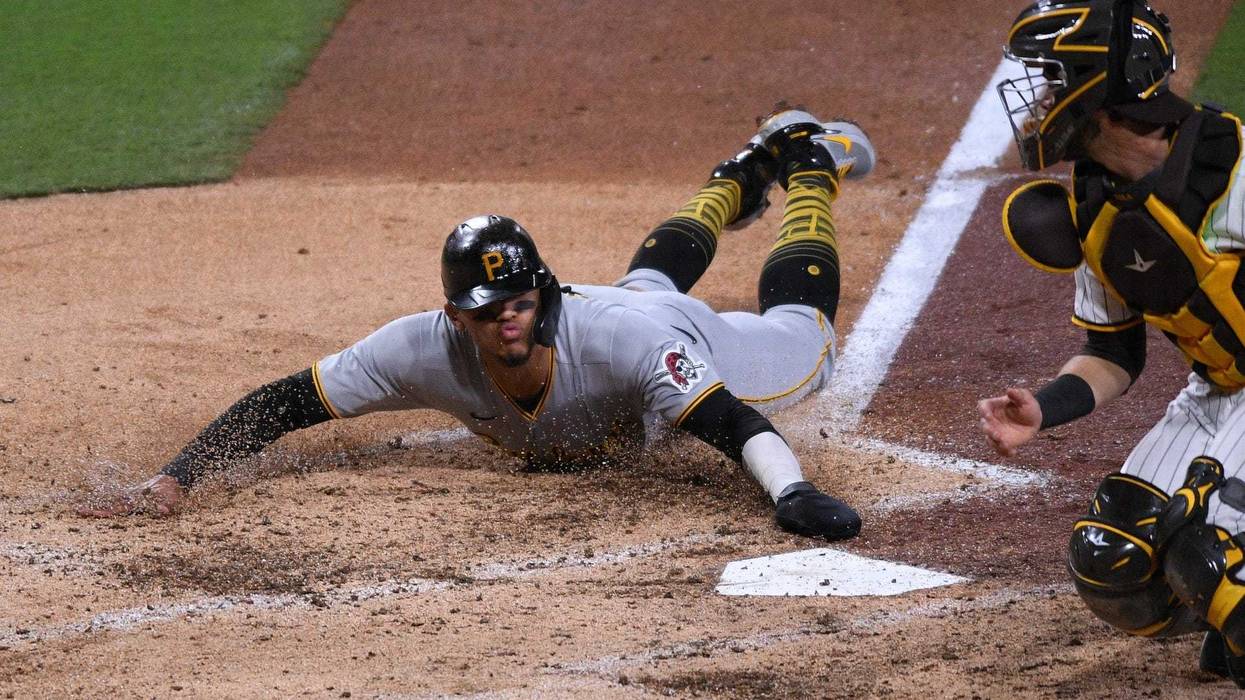 Erik Gonzalez sliding home safe