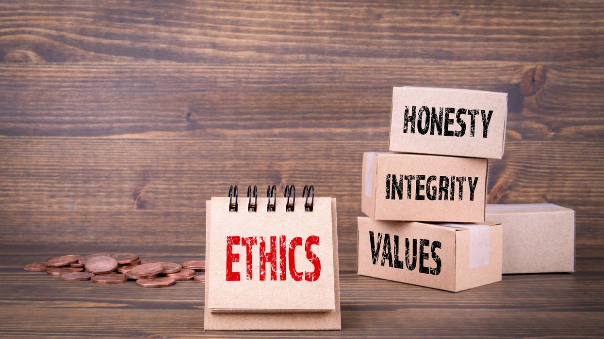 Ethics concept: paper boxes on wooden background