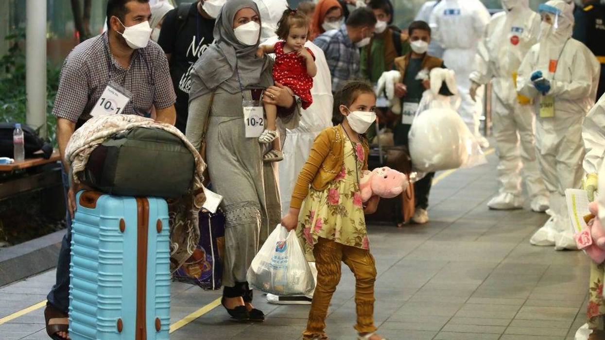 Evacuees from Afghanistan arrive at Incheon International Airport on August 26, 2021 in Incheon, South Korea. A total of 378 Afghans arrived in South Korea on Thursday as part of Seoul's efforts to evacuate local co-workers of the country's embassy and other facilities in the war-torn nation after the Taliban's seizure of power.