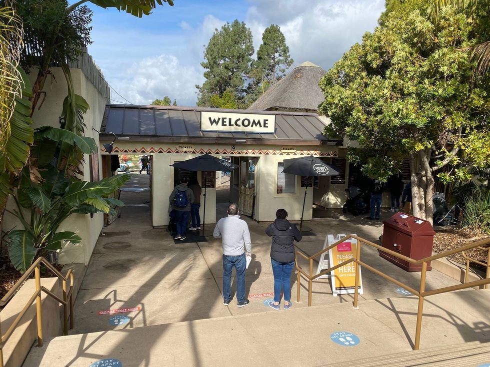 Excited visitors file in to the Oakland Zoo, the first to come through the gates after a two-month closure because of COVID-19 restrictions.
