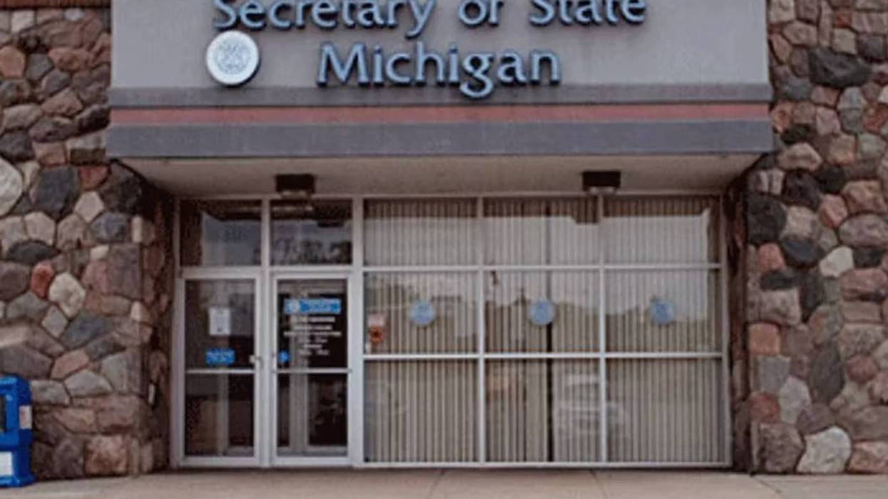 Exterior of a Secretary of State Michigan building with stone walls and glass entrance.