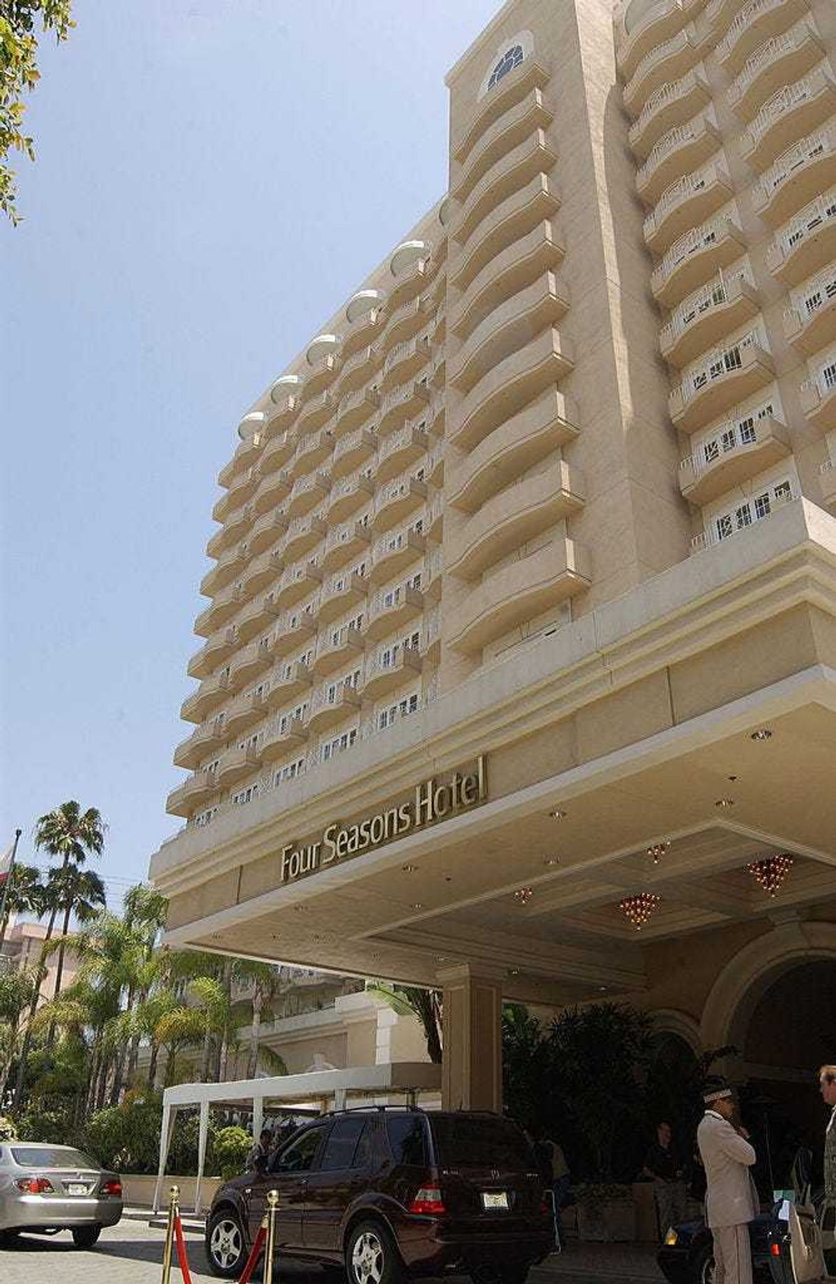 Exterior view of the main entrance into the Four Seasons Hotel, Beverly Hills, California, June 1, 2002. A uniformed valet is visible at the lower right and several hotel guest can been seen behind him under the awning. (Photo by Robert Mora/Getty Images)