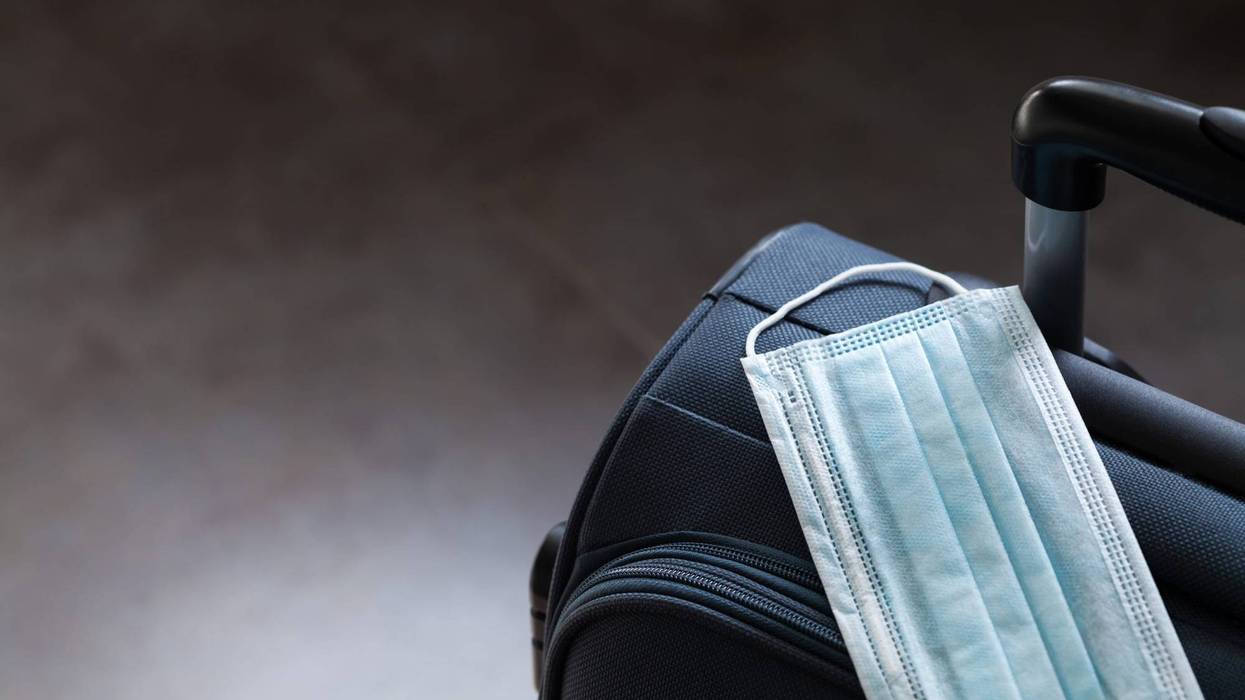 Face mask on suitcase