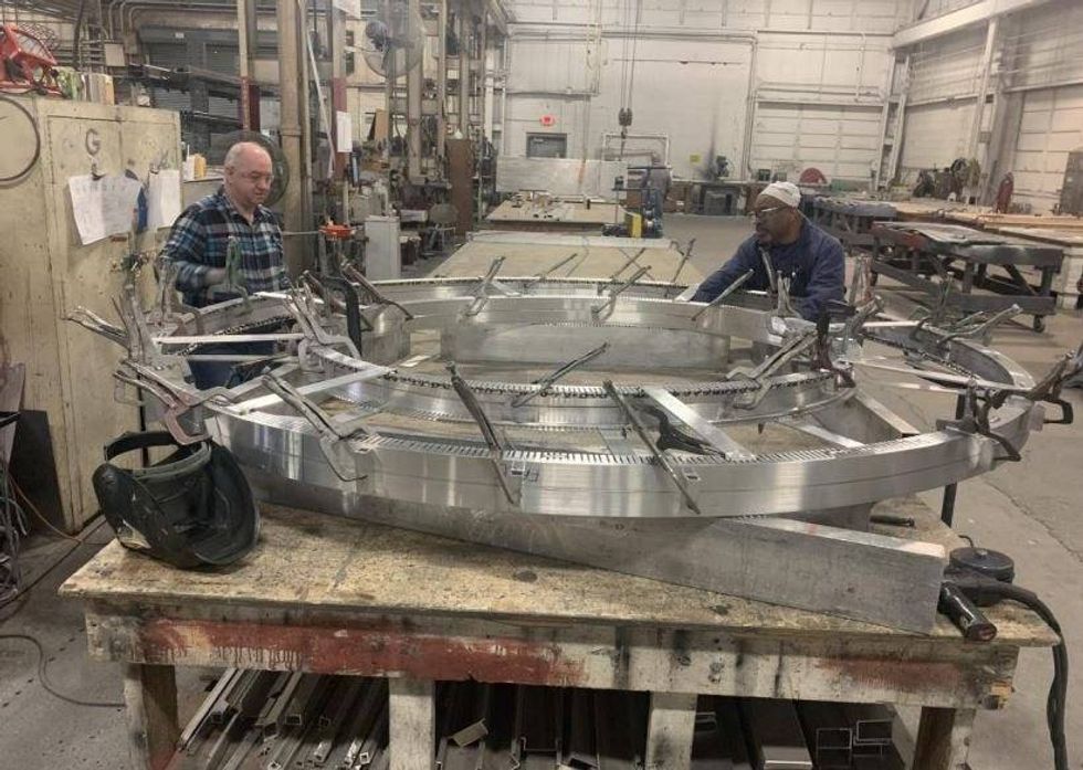 Fairmont Sign Company employees working on letter for Detroit Gateway sign