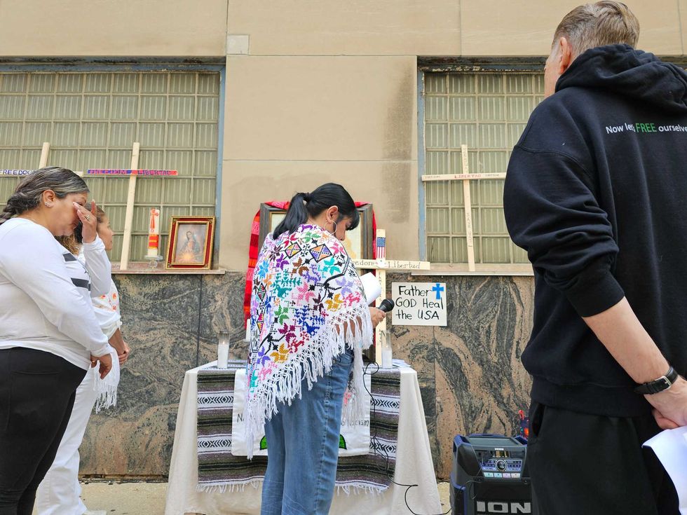 Faith leaders in Chicago burn candles and pray in vigil outside the ICE field office June 19, 2025.