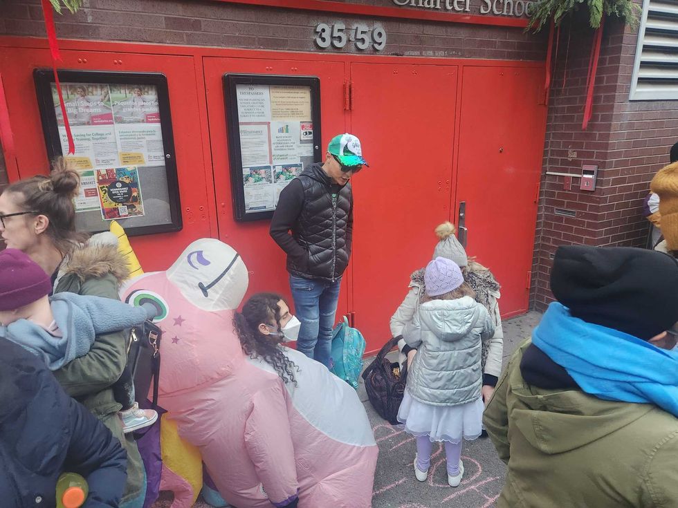 Families play and socialize behind the line of counter protesters.