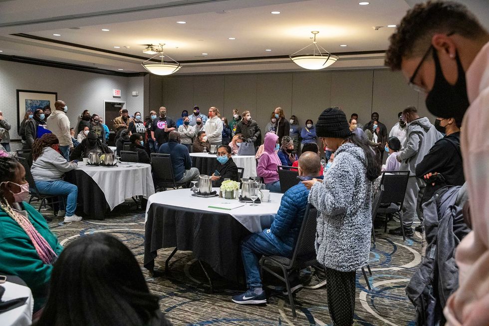 Family and friends wait for word of their loved ones who were at the FedEx Ground facility during a shooting in Indianapolis, Thursday night, April 15, 2021