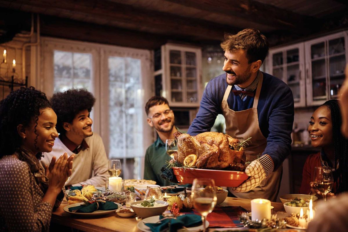 Family at Thanksgiving dinner stock photo.