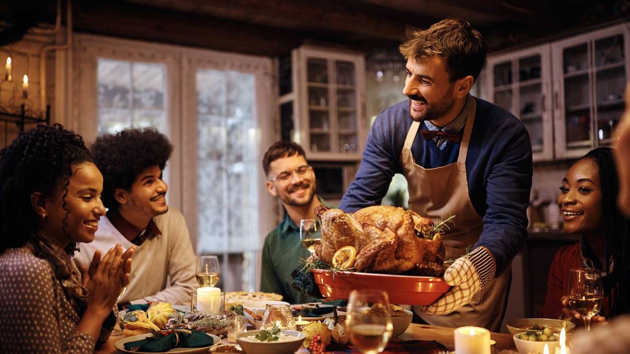 Family at Thanksgiving dinner stock photo.
