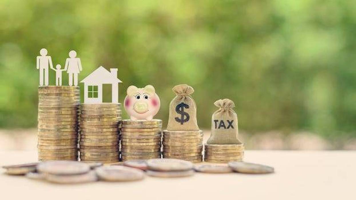 Family couple, home model, piggy bank, dollar and tax bags on stacks of rising coins