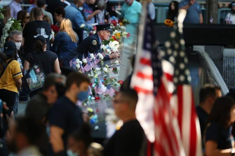 Family, friends and colleagues of those killed in the 9/11 and the 1993 bombing terror attacks participate in the annual commemoration ceremony at the National 9/11 Memorial and Museum on September 11, 2021 in New York City.