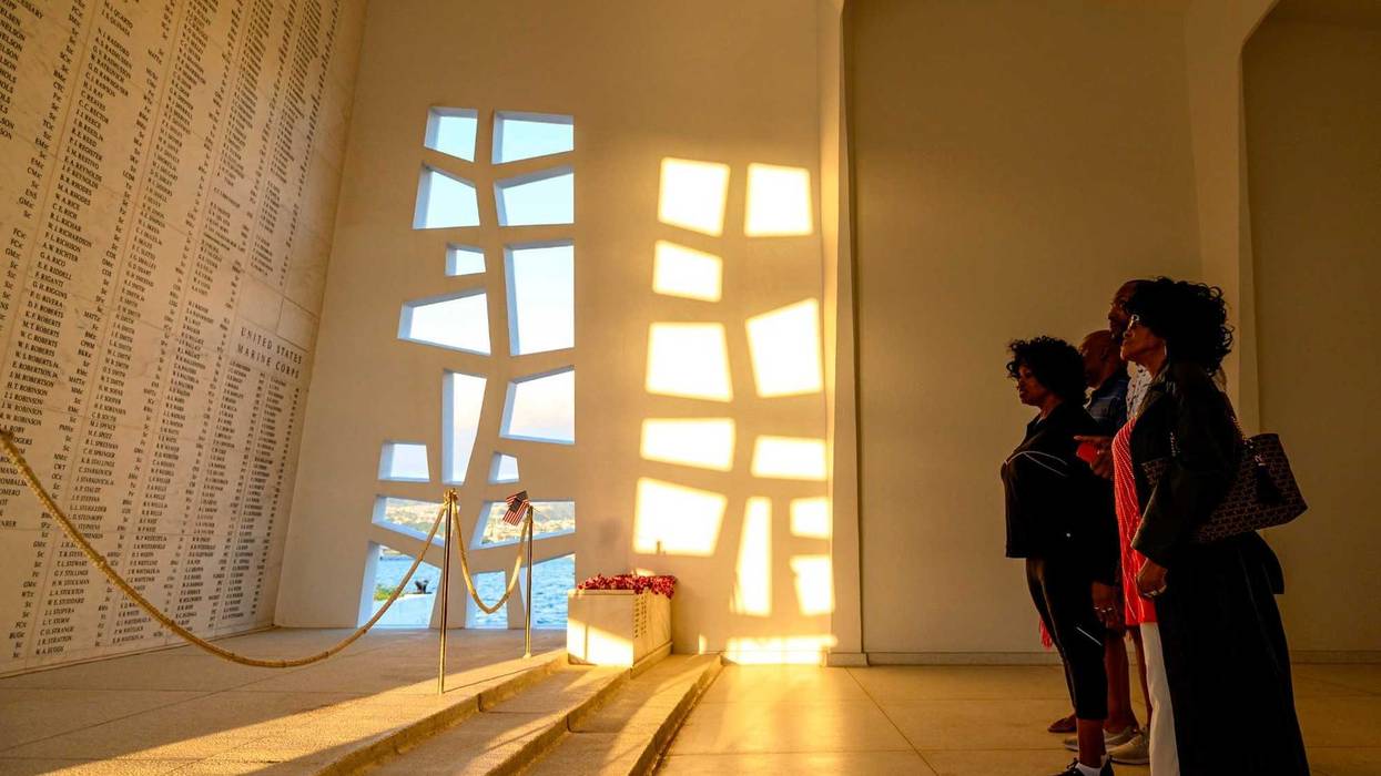 Family members of World War II hero Doris “Dorie” Miller stand at the end of the USS Arizona Memorial while on a boat tour of Joint Base Pearl Harbor-Hickam