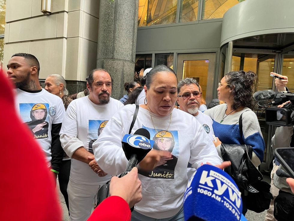Family of Eddie Irizarry and supporters speak to reporters outside the Center for Criminal Justice.