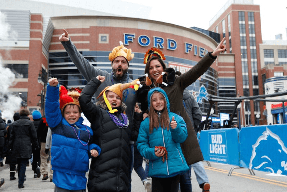 Family poses in Thanksgiving Day gear before the Detroit Lions game at Ford Field in 2022
