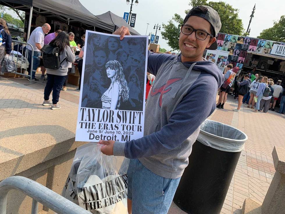 Fan poses with Taylor Swift poster outside Ford Field