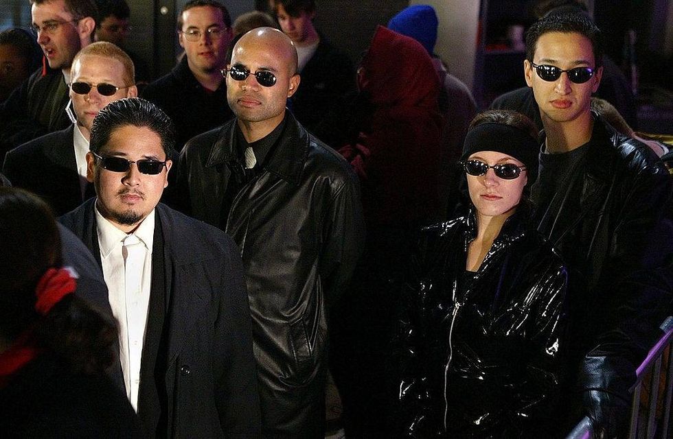 Fans dressed as characters from the movie line up for the opening of the film Matrix Revolution at Graumann