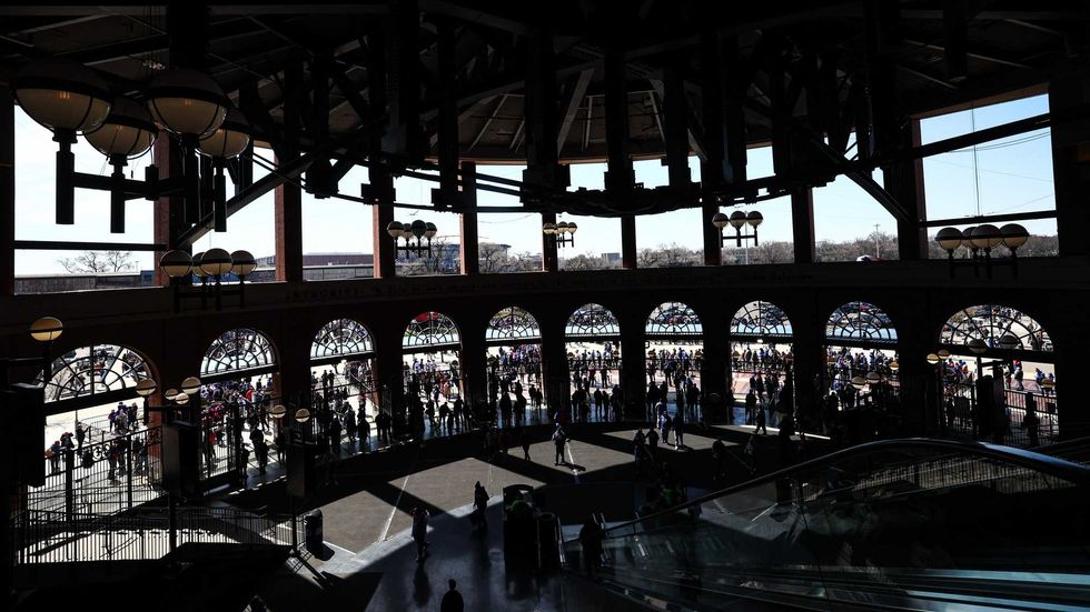 Fans enter Citi Field before the opening day game between the New York Mets and the Milwaukee Brewers