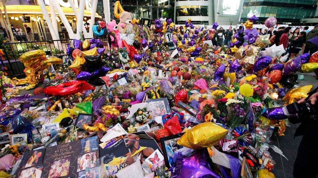 Fans gather at a memorial for the late Kobe Bryant in front of Staples Center in Los Angeles, Sunday, Feb. 2, 2020. Bryant, the 18-time NBA All-Star who won five championships and became one of the greatest basketball players of his generation during a 20