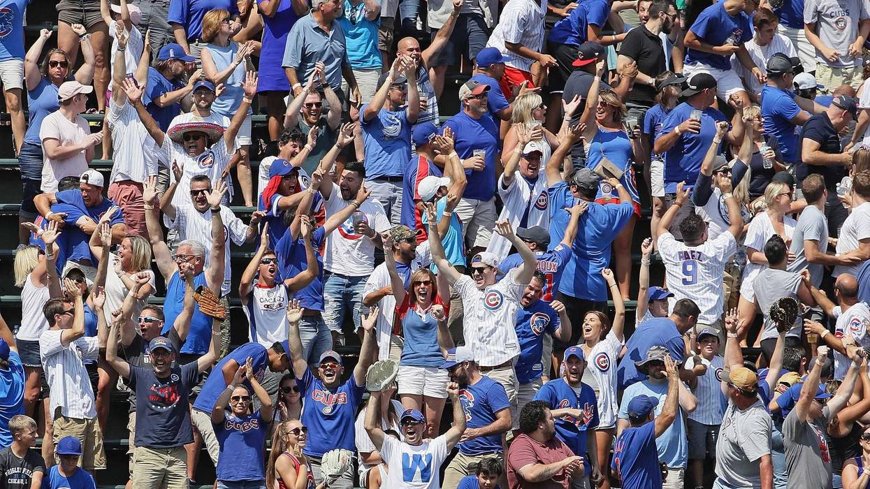 Fans in the bleachers cheer after Ian Happ of the Chicago Cubs hit a grand slam home run in the 4th inning against the Oakland Athletics at Wrigley Field on August 07, 2019 in Chicago, Illinois.