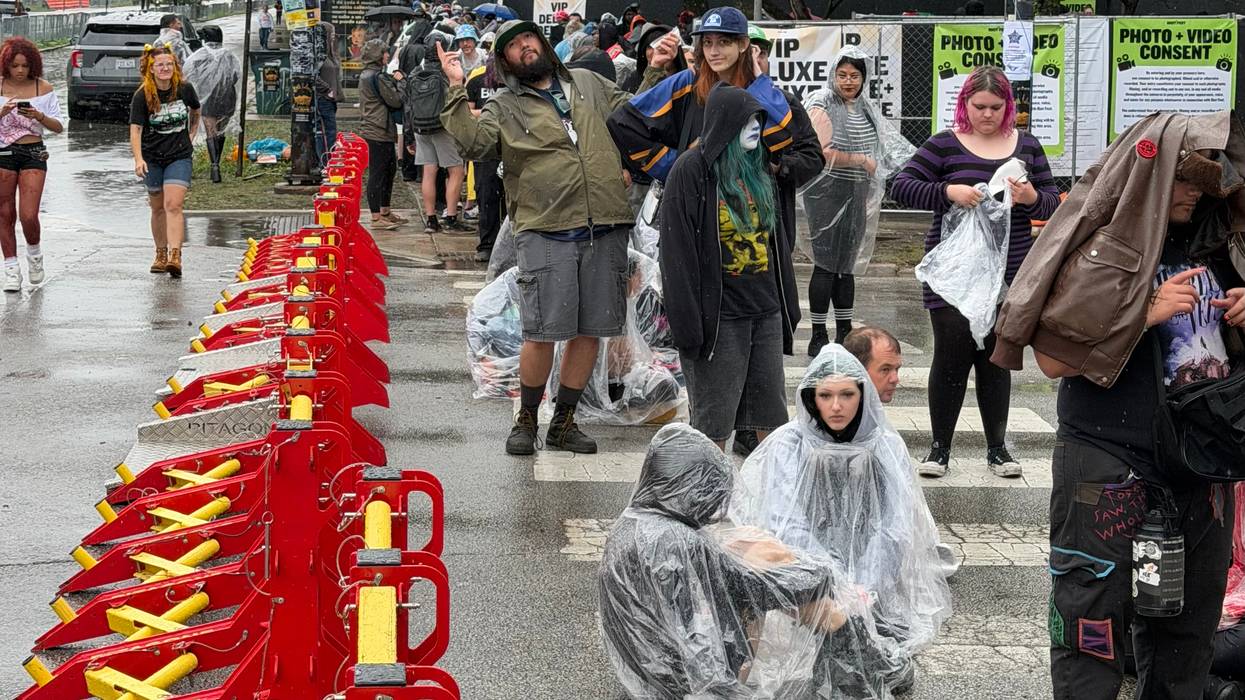 Fans line up outside a rainy Douglass Park, 1401 S. Sacramento Blvd., ahead of the third day of Riot Fest.