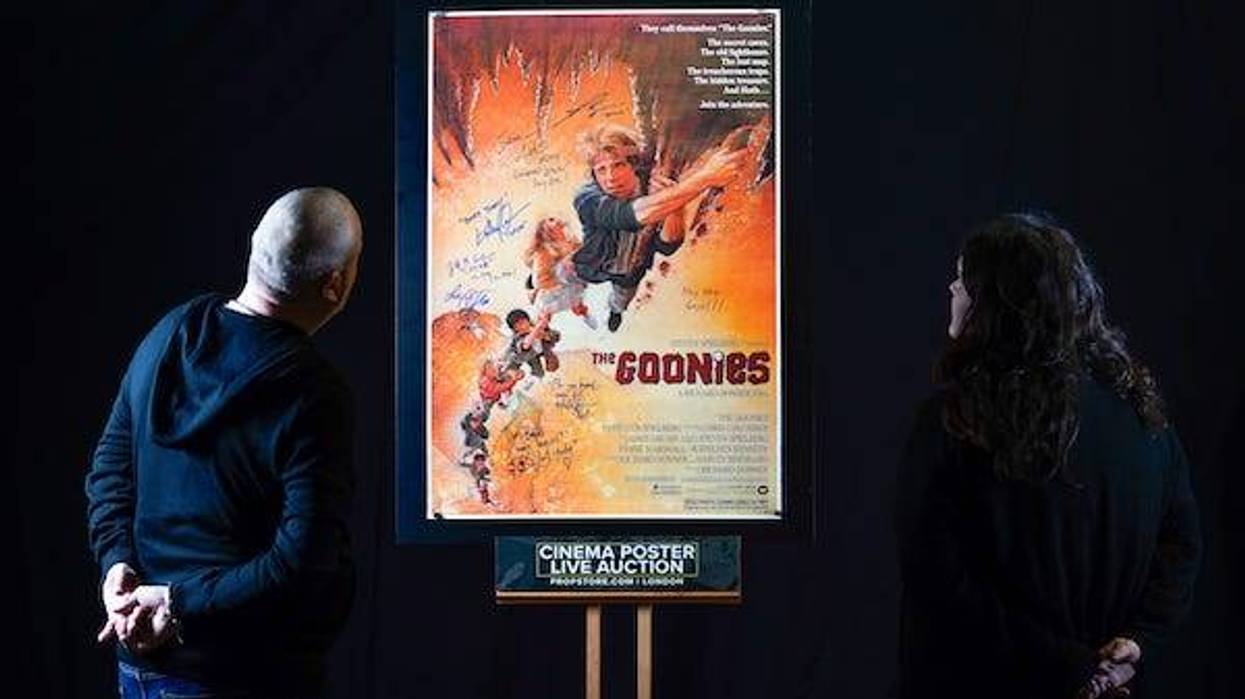 Fans look at an autographed poster of ‘The Goonies’