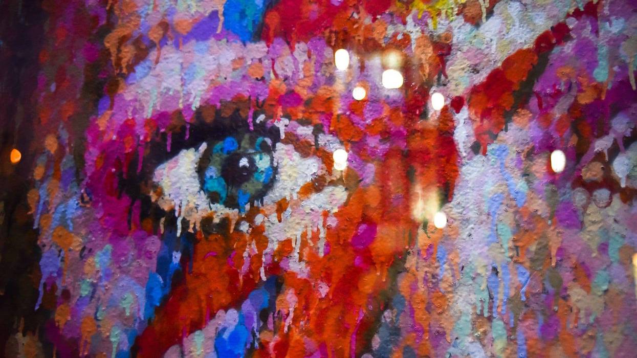 Fans pay tributes with flowers, candles and photos of David Bowie