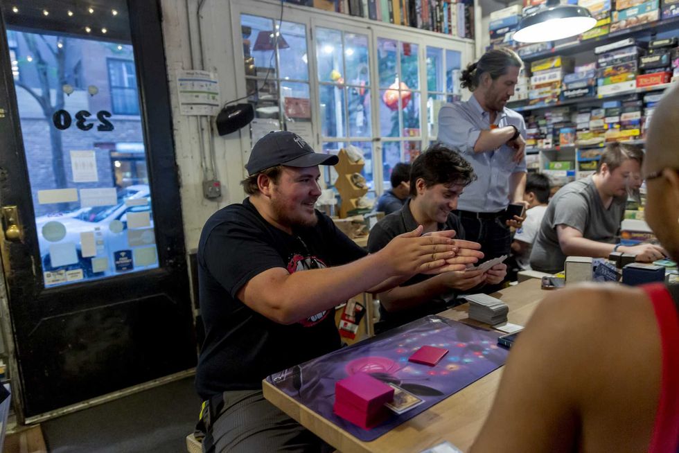 Fans prepare to play a Magic: The Gathering during a weekly tournament at the Uncommons hobby shop in New York, U.S., on Thursday, June 27, 2019.