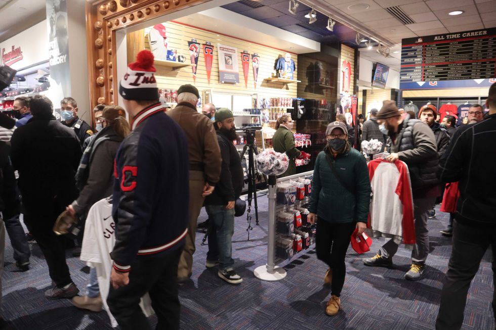 Fans stand in line to finalize purchases of new Cleveland Guardians gear during the club