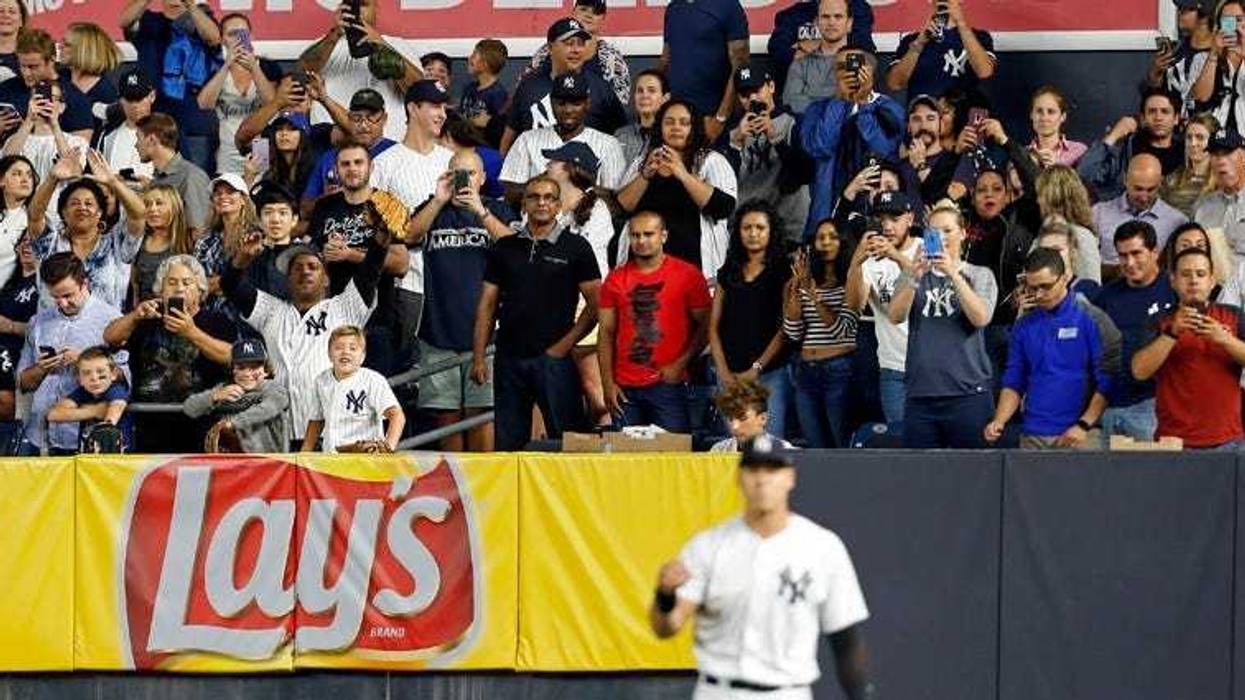 Fans take photos of Yankees right fielder Aaron Judge as he warms up against the Toronto Blue Jays during the eighth inning on Sept. 14, 2018, at Yankee Stadium.