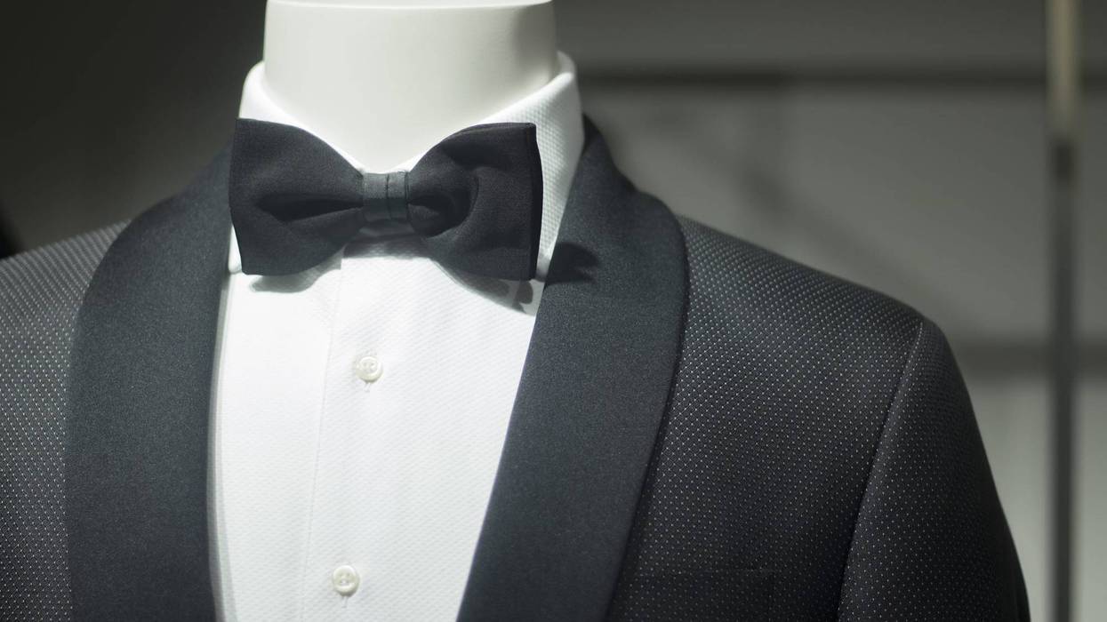 fashion mannequin in department store boutique window wearing evening suit dinner jacket and bow tie