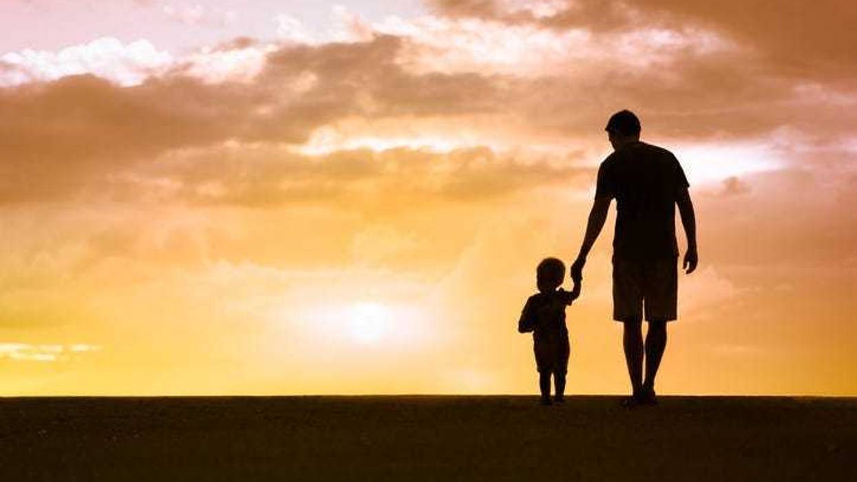 Father and son walking at sunset