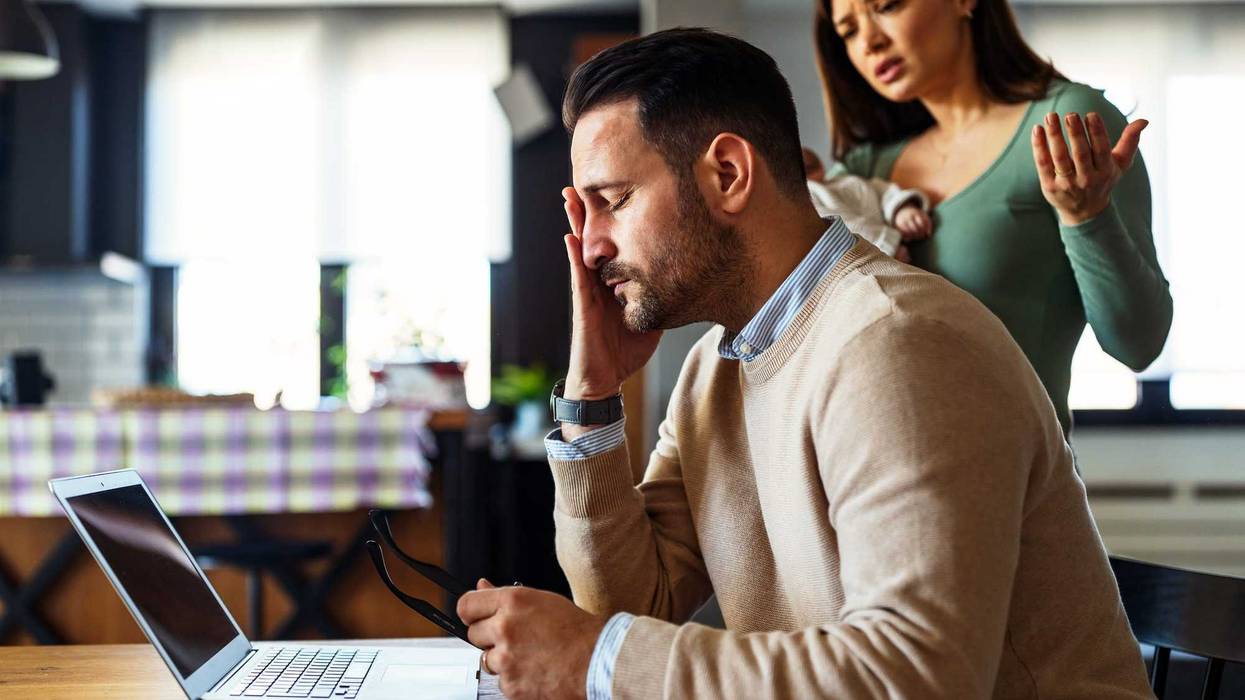 Father businessman try to work on laptop from home while wife arguing with him. Work from home concept.