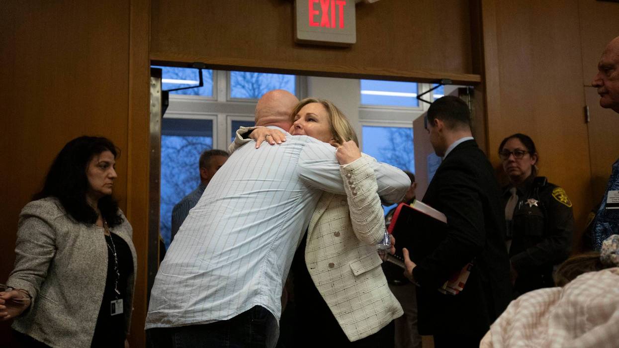 Father of Oxford High School victim Justin Shilling hugs Oakland County Prosecutor Karen McDonald after James Crumbley's guilty verdict.