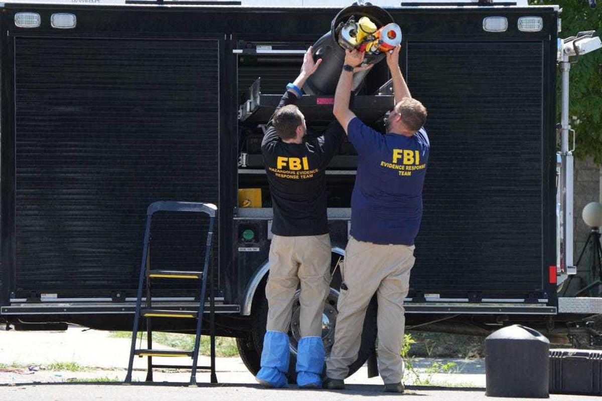 FBI officials unload the equipment as they process the home of Craig Robertson who was shot and killed by the FBI in a raid on his home this morning on August 9, 2023 in Provo, Utah. The FBI was investigating alleged threats by Robertson to President Biden who is visiting Salt Lake City today and tomorrow. (Photo by George Frey/Getty Images)