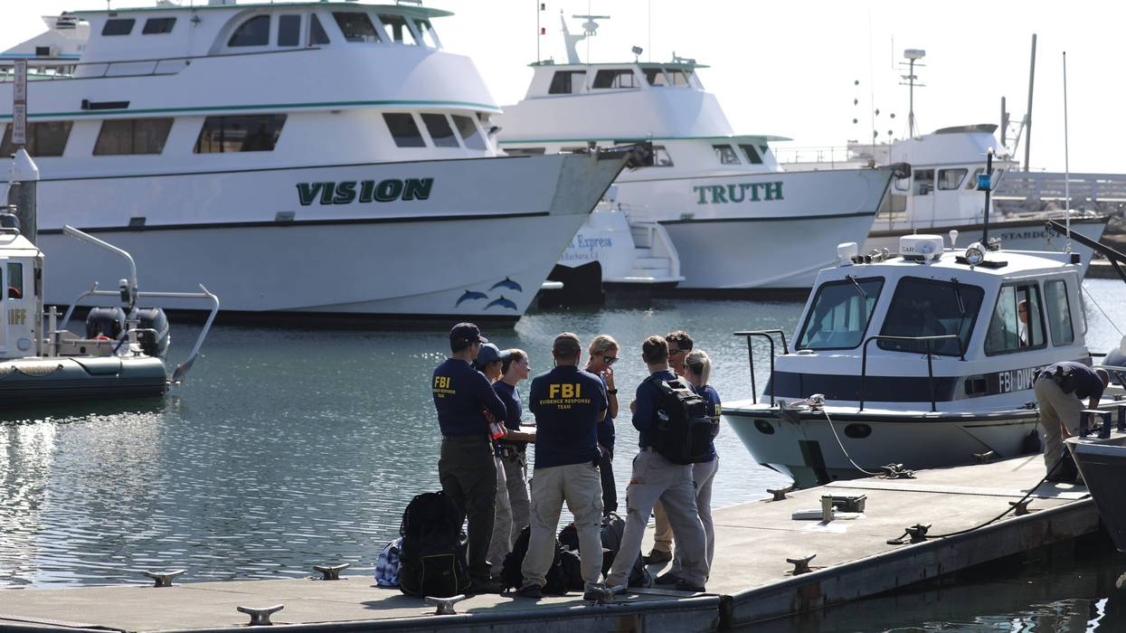 FBI personnel stand on a jetty in front of the ships Vision (L) and Truth, sister vessels of the diving ship Conception, in Santa Barbara Harbor on September 4, 2019 in Santa Barbara, California.