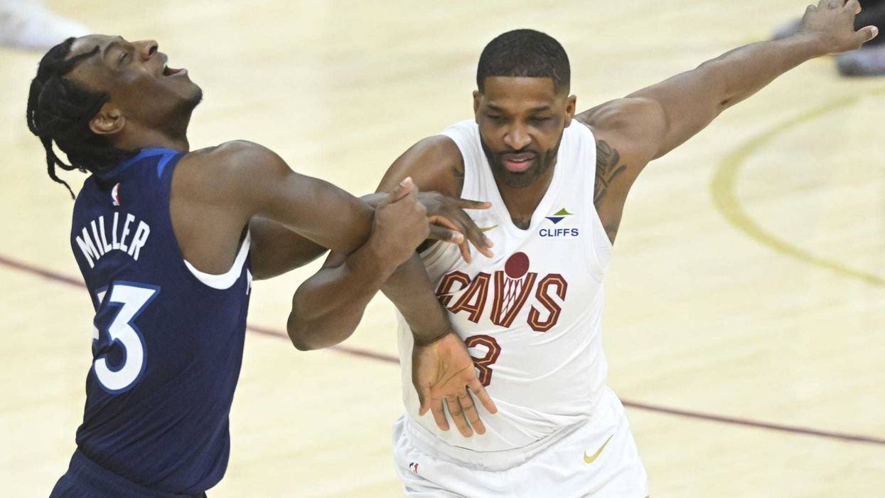 Feb 10, 2025; Cleveland, Ohio, USA; Minnesota Timberwolves forward Leonard Miller (33) and Cleveland Cavaliers center Tristan Thompson (13) get tangled in the fourth quarter at Rocket Mortgage FieldHouse.