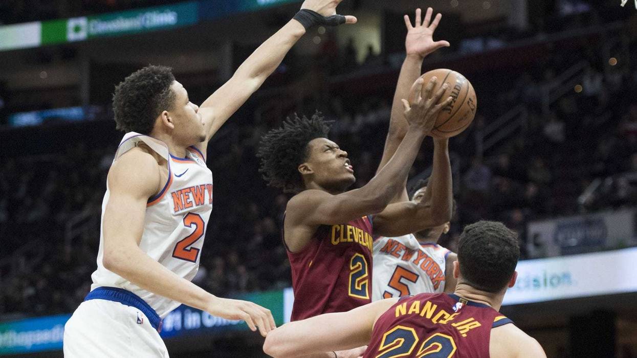 Feb 11, 2019; Cleveland, OH, USA; Cleveland Cavaliers guard Collin Sexton (2) drives to the basket between New York Knicks forward Kevin Knox (20) and guard Dennis Smith Jr. (5) during the second half at Quicken Loans Arena. Mandatory Credit: Ken Blaze-US