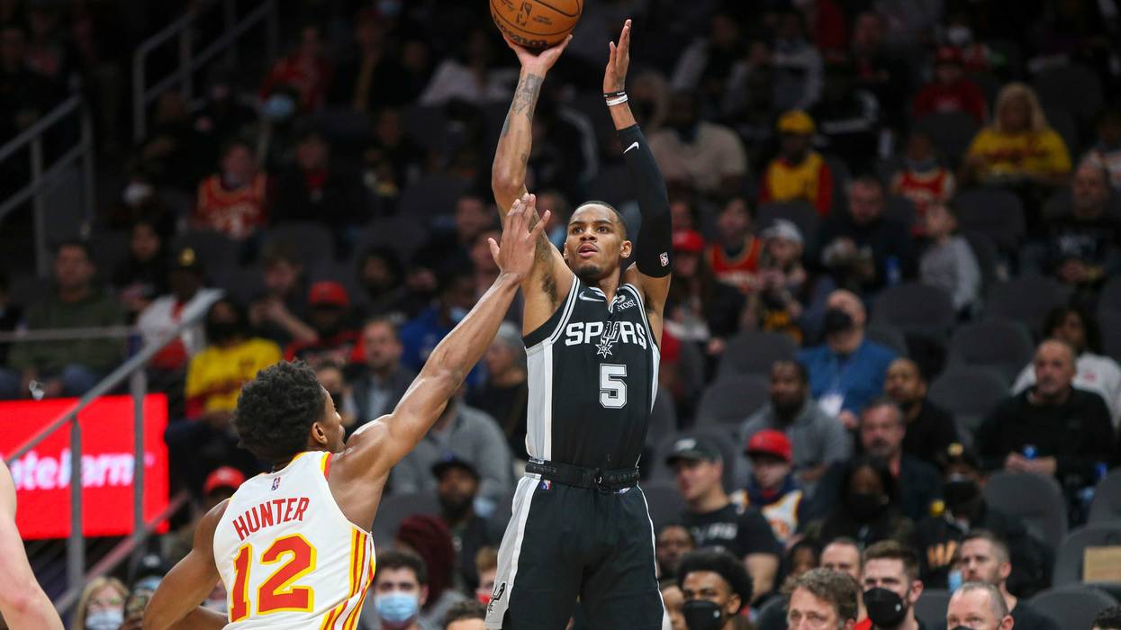 Feb 11, 2022; Atlanta, Georgia, USA; San Antonio Spurs guard Dejounte Murray (5) shoots over Atlanta Hawks forward De'Andre Hunter (12) in the first quarter at State Farm Arena.