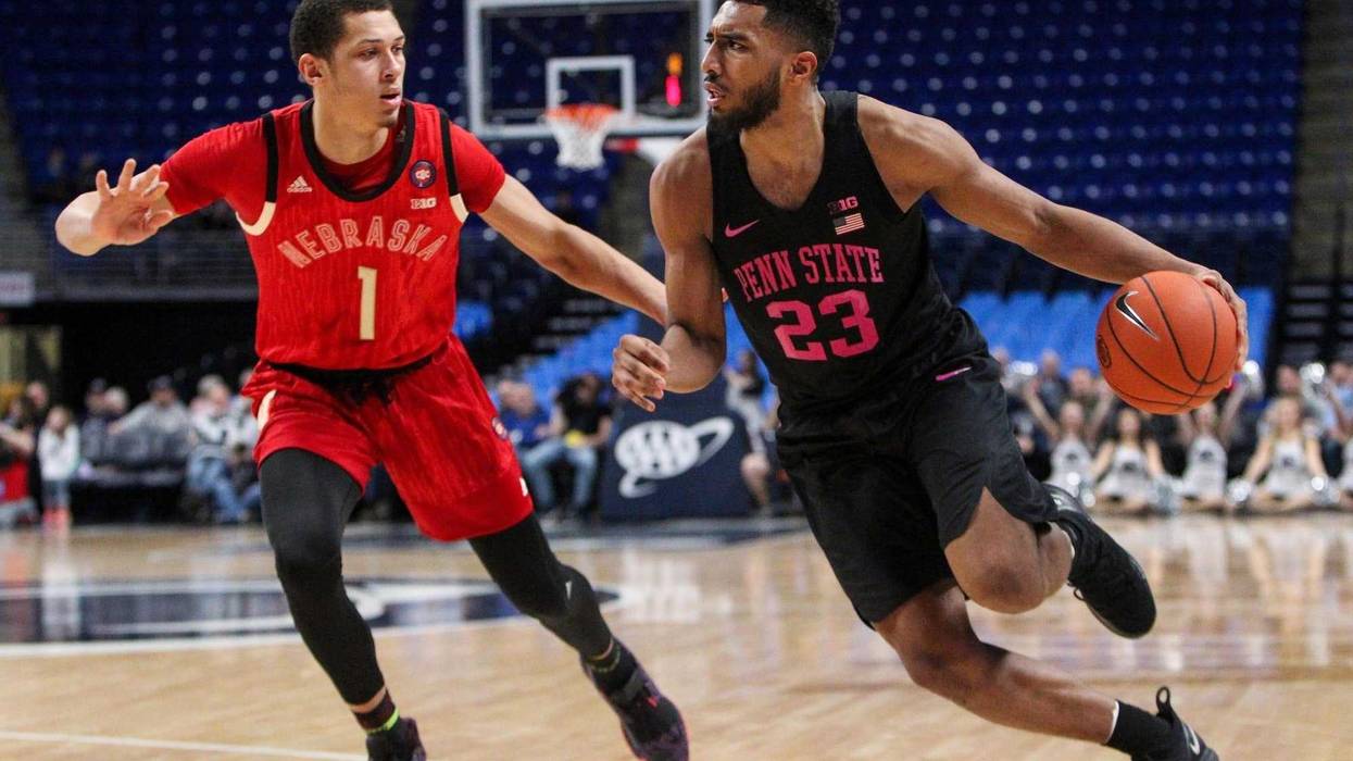 Feb 19, 2019; University Park, PA, USA; Penn State Nittany Lions guard Josh Reaves (23) dribbles the ball around Nebraska Cornhuskers guard Amir Harris (1) during the first half at Bryce Jordan Center.