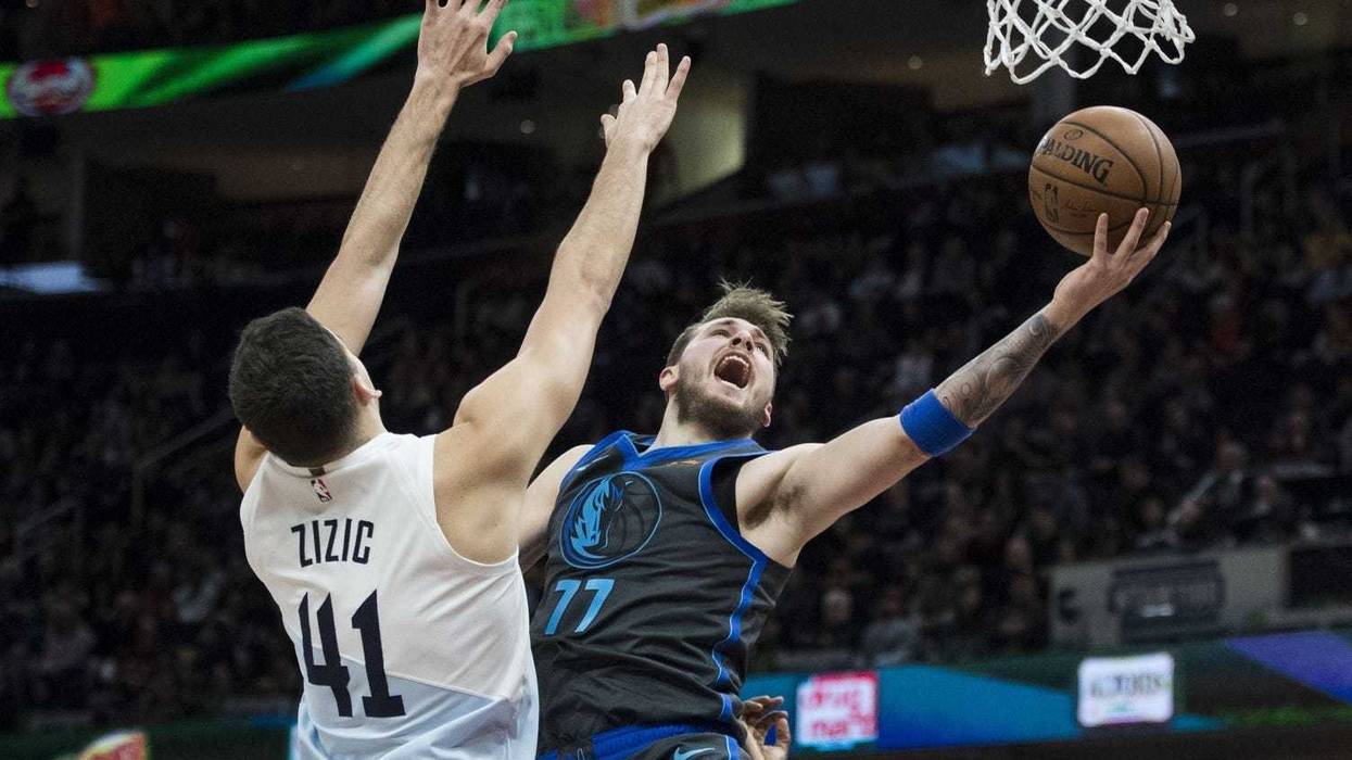 Feb 2, 2019; Cleveland, OH, USA; Dallas Mavericks forward Luka Doncic (77) drives to the basket against Cleveland Cavaliers center Ante Zizic (41) during the first half at Quicken Loans Arena. Mandatory Credit: Ken Blaze-USA TODAY Sports