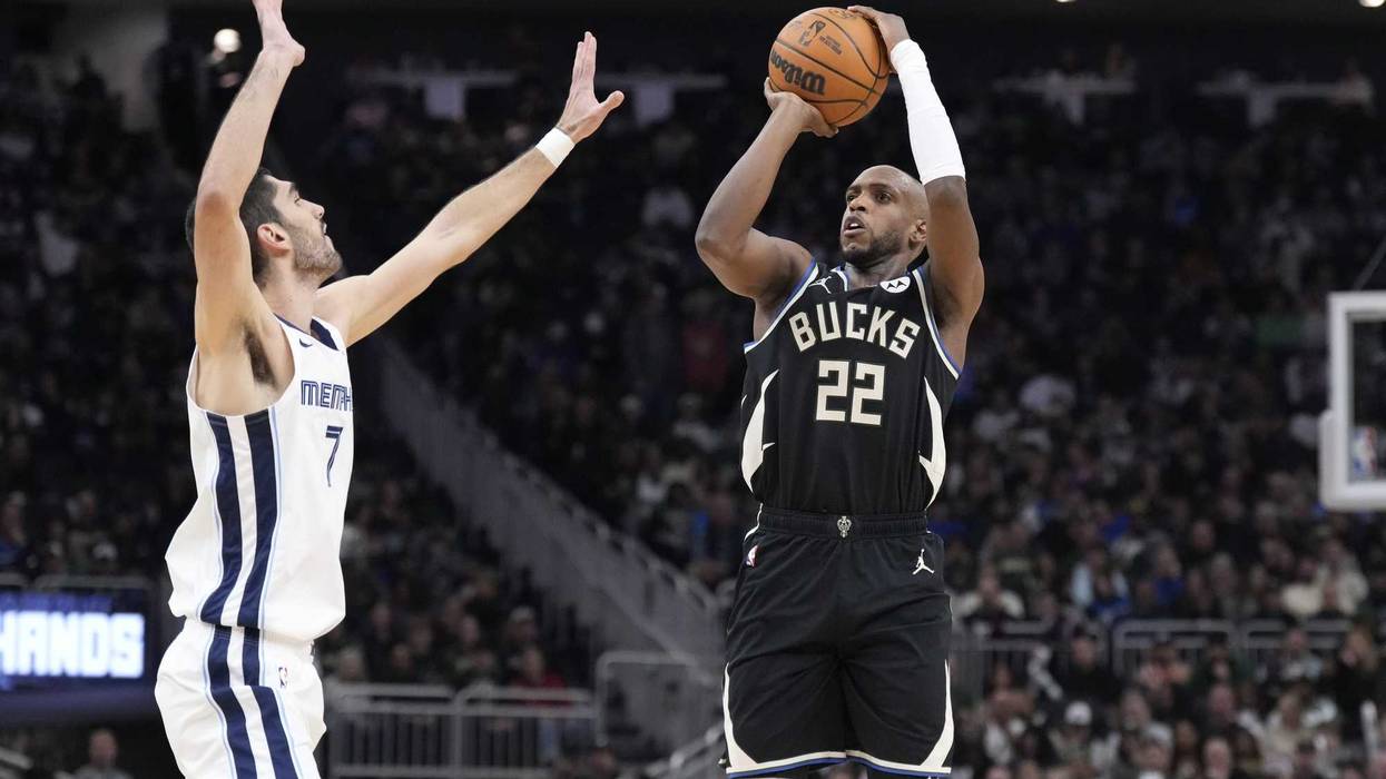 Feb 2, 2025; Milwaukee, Wisconsin, USA; Milwaukee Bucks forward Khris Middleton (22) puts up a shot against Memphis Grizzlies forward Santi Aldama (7) in the first half at Fiserv Forum. Mandatory Credit: Michael McLoone-Imagn Images