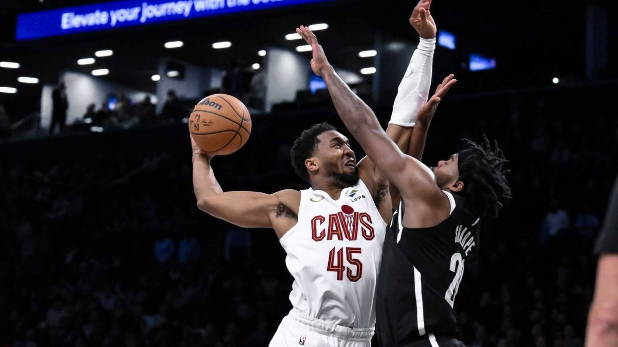 Feb 20, 2025; Brooklyn, New York, USA; Cleveland Cavaliers guard Donovan Mitchell (45) tries to dunk the ball as Brooklyn Nets center Day'Ron Sharpe (20) defends during the second half at Barclays Center.