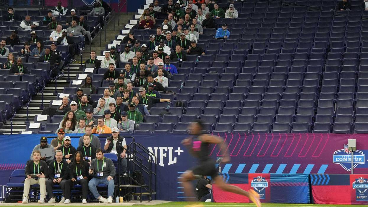 Feb 28, 2025; Indianapolis, IN, USA; NFL scouts look on as athletes run the 40 yard dash during the 2025 NFL Scouting Combine at Lucas Oil Stadium. Mandatory Credit: Kirby Lee-Imagn Images