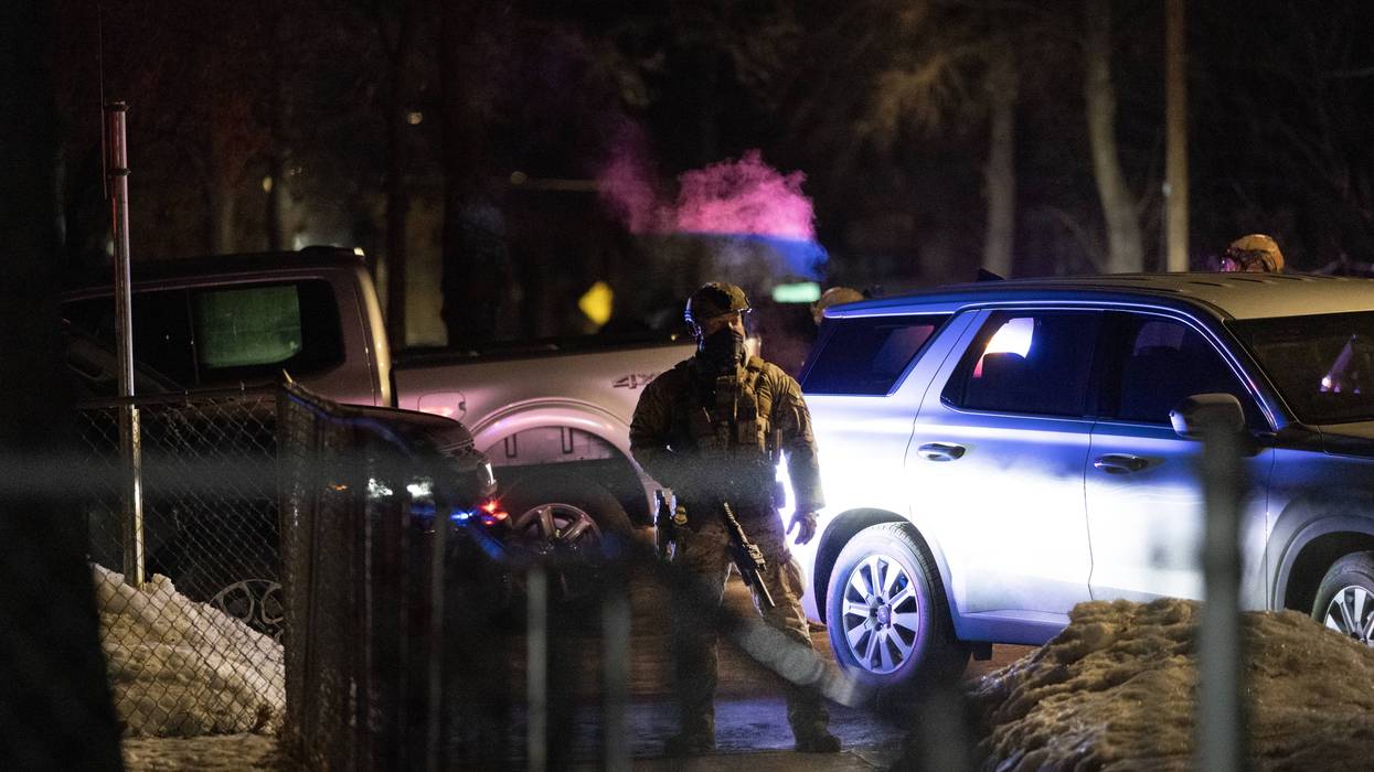 Federal agents guard a perimeter following a shooting incident as angry residents protest their presence in the city on January 14, 2026 in Minneapolis, Minnesota.