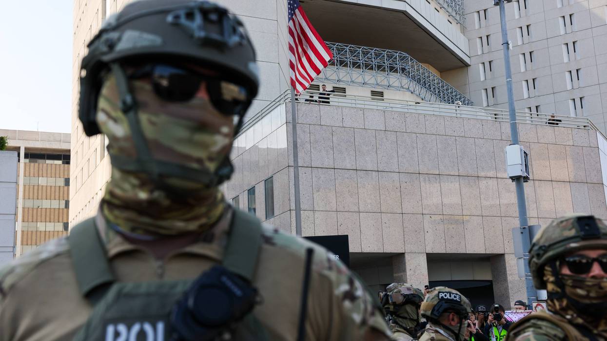 Federal agents guard outside of a federal building and Immigration and Customs Enforcement (ICE) detention center in downtown Los Angeles as demonstrations continue after a series of immigration raids began last Friday on June 13, 2025, in Los Angeles, California.